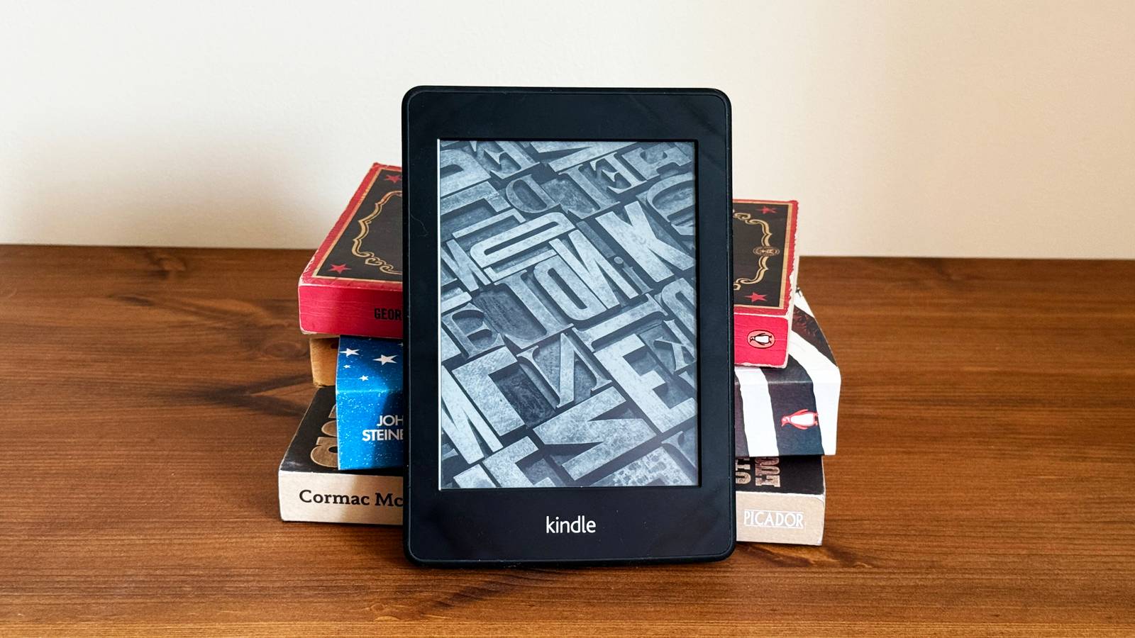 /images/a-stack-of-paper-books-with-a-kindle-ereader-in-front-of-them.jpg