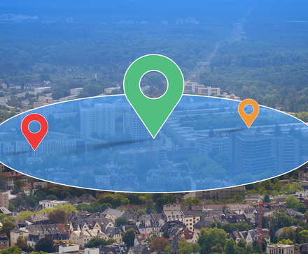 /images/aerial-view-of-a-city-with-large-map-location-pins-and-a-blue-circular-zone-overlay.png