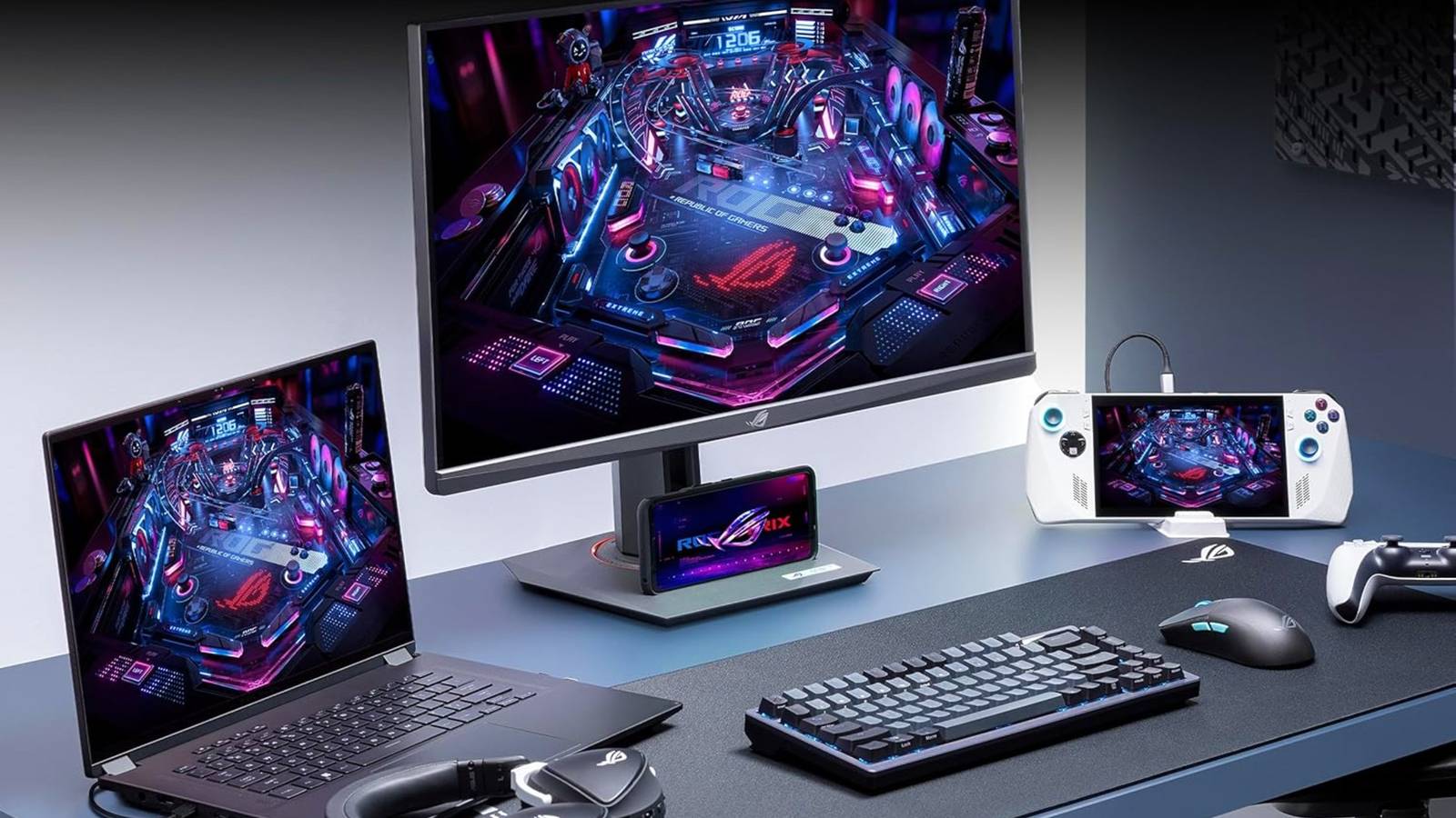 /images/asus-rog-strix-gaming-monitor-next-to-a-keyboard-handheld-phone-controller-headset-and-laptop-on-a-desk.jpg