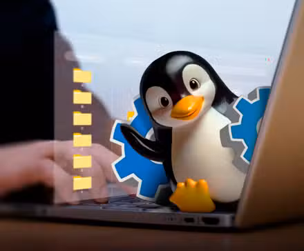 /th/images/a-hand-using-a-laptop-and-linux-mascot-coming-out-of-the-screen-with-a-gear-and-some-files-behind.jpg