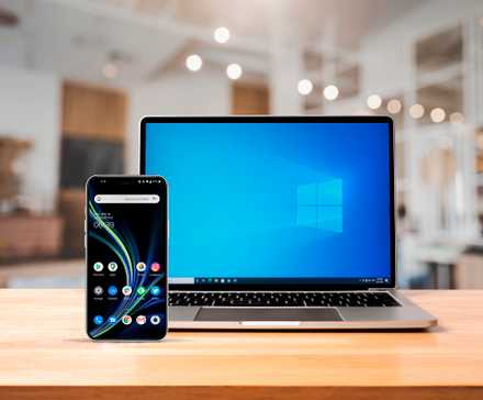 /th/images/a-notebook-above-a-wooden-desk-with-a-windows-screen-and-an-android-smartphone-on-the-front-left-side-1.jpg