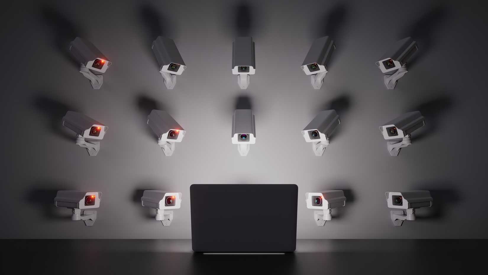 /th/images/wall-mounted-cameras-focus-on-a-laptop-screen-symbolizing-surveillance-and-control.jpg